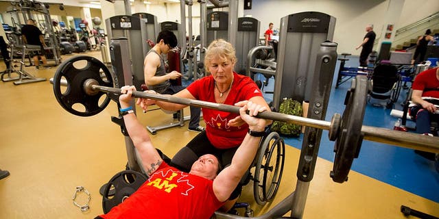 TORONTO, ON - MARCH 23  -   Retired Corporal Christine Gauthier spots Retired Corporal Natacha Dupuis. Canadian Invictus Games athletes during their last training day before they head off for the 2016 games. (Carlos Osorio/Toronto Star via Getty Images)