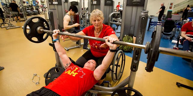 TORONTO, ON - MARCH 23  -   Retired Corporal Christine Gauthier spots Retired Corporal Natacha Dupuis. Canadian Invictus Games athletes during their last training day before they head off for the 2016 games. (Carlos Osorio/Toronto Star via Getty Images)