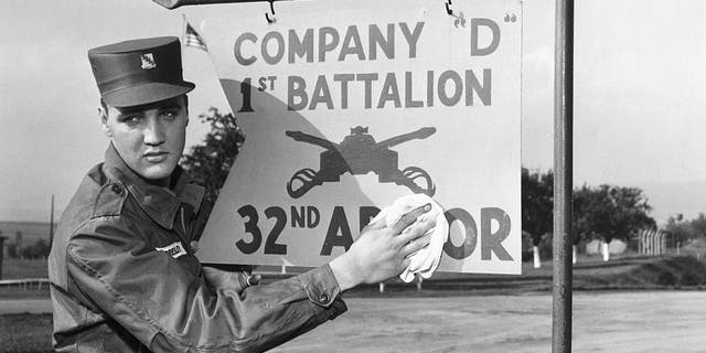 Elvis Presley poses for the camera during his military service at a U.S. base in Germany. 