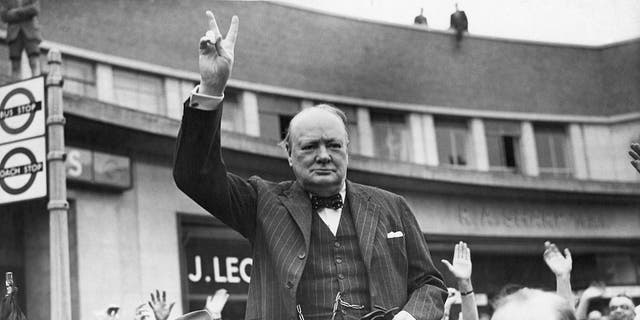 Sir Winston Churchill, campaigning for reelection to the Prime Minister's seat, gives the "V" victory sign to people during a rally at Uxbridge. 