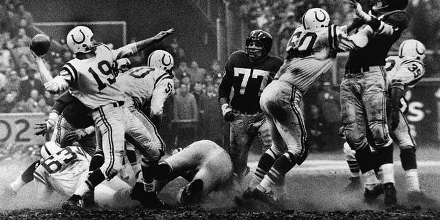 American quarterback Johnny Unitas (left) of the Baltimore Colts is shown as he's about to throw a pass during a play in "sudden death" overtime of the NFL Championship game against the New York Giants, Yankee Stadium, New York, Dec. 28, 1958. The Colts won 23-17. 