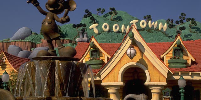 A bronze Mickey Mouse water fountain sits inside the Toontown section of Disneyland in California.