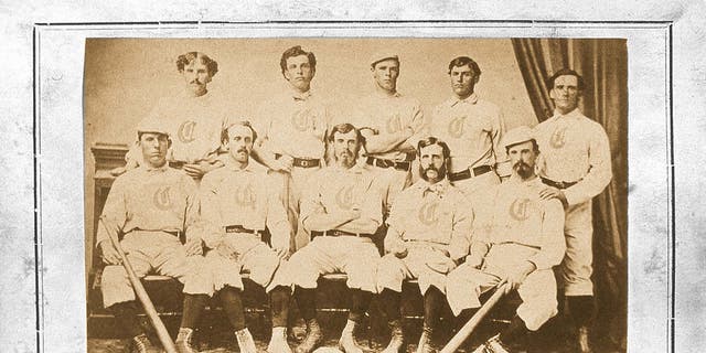 The Red Stocking Baseball Club of Cincinnati Ohio poses for a team photo in a studio in 1869, which was issued as a trade card. The Red Stocking, the first professional baseball team, and the first college football game, both emerged in 1869. They were part of a post-Civil war obsession in America with sports as entertainment. 