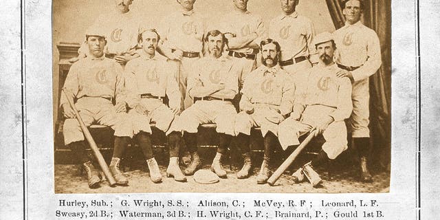 The Red Stocking Baseball Club of Cincinnati Ohio poses for a team photo in a studio in 1869, which was issued as a trade card. The Red Stocking, the first professional baseball team, and the first college football game, both emerged in 1869. They were part of a post-Civil war obsession in America with sports as entertainment. 