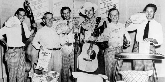 Hank Williams (center, hat and guitar) and the Drifting Cowboys pose at WSM Radio's studio in Nashville, Tennessee, circa 1950.