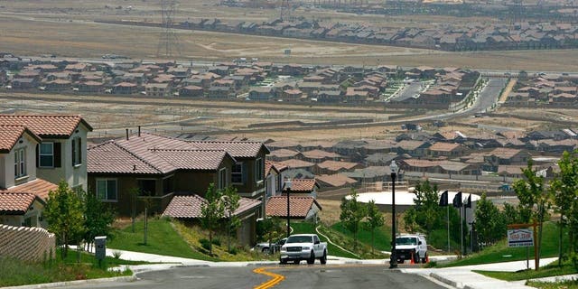 RANCHO CUCAMONGA, CA - JULY 11: A gated community housing project overlooks a rural landscape that is being rapidly converted into a vast suburb as a construction boom continues in San Bernardino County. (Photo by David McNew/Getty Images)