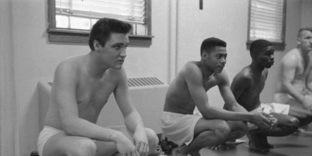 Along with fellow recruits, American musician Elvis Presley (1935-1977) waits during a physical examination upon their conscription into the U.S. Army at Fort Smith, Arkansas, on March 25, 1958.   