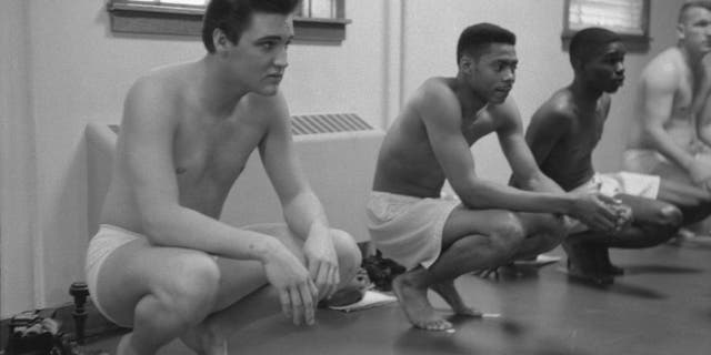 Along with fellow recruits, American musician Elvis Presley (1935-1977) waits during a physical examination upon their conscription into the U.S. Army at Fort Smith, Arkansas, on March 25, 1958.   