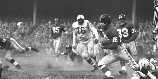 New York Giants star Frank Gifford (no. 16) in action, rushing vs. Baltimore Colts, Bronx, New York, on Dec. 28, 1958. 