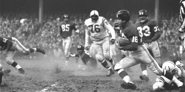 New York Giants star Frank Gifford (no. 16) in action, rushing vs. Baltimore Colts, Bronx, New York, on Dec. 28, 1958.
