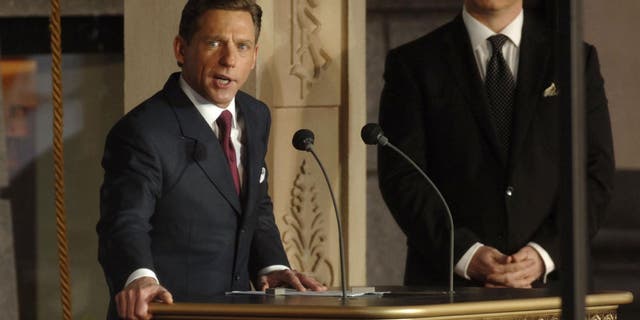 David Miscavige (L), chairman of the board of the Religious Technology Centre and leader of the Scientology religion, addressing the crowd during the opening of the Church of Scientology's new church in London on Oct. 22, 2006.