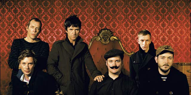 UNITED STATES - NOVEMBER 20: Photo of Modest Mouse and Johnny MARR and Tom Peloso and Joe Plummer and Eric Judy and Jeremiah Green and Isaac Brock; Posed studio group portrait L-R Tom Peloso, Joe Plummer (front), Johnny Marr, Isaac Brock, Jeremiah Green and Eric Judy 