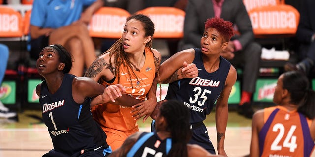 Elizabeth Williams, #1 of the Atlanta Dream, Brittney Griner, #42 of the Phoenix Mercury, and Angel McCoughtry, #35 of the Atlanta Dream, wait for the rebound during the game between the two teams on July 8, 2018 at McCamish Pavilion in Atlanta.