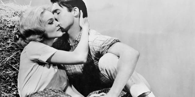 Diane McBain and Will Hutchins lie together in publicity portrait for the film "Claudelle Inglish," 1961.