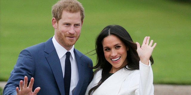 Prince Harry and Meghan Markle pose for a photograph in the Sunken Garden at Kensington Palace in London on Nov. 27, 2017, following the announcement of their engagement.