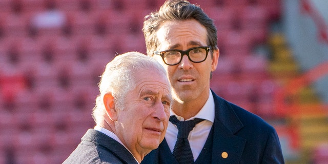 King Charles III speaks with co-owner of Wrexham AFC Ryan Reynolds during a visit to Wrexham Association Football Club (AFC) on December 9, 2022, in Wrexham, Wales.
