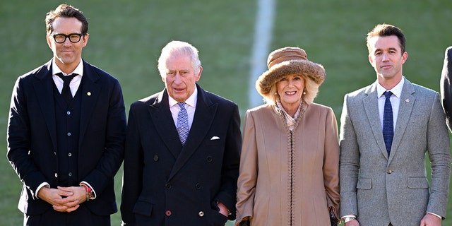 King Charles III and Camilla, Queen Consort meet with co-owners of Wrexham AFC, Ryan Reynolds and Rob McElhenney during their visit to Wrexham AFC on December 9, 2022, in Wrexham, Wales. Formed in 1864, Wrexham AFC is the third-oldest professional football team in the world. The club was taken over by Hollywood actors Ryan Reynolds and Rob McElhenney in late 2020. 