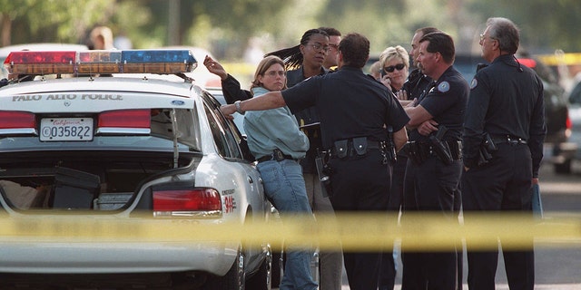 Palo Alto Police Department officers conduct an impromptu conference at the scene on Ferne Avenue where three bodies were discovered in a home. Police would reveal little about the tragedy, but said they were looking into the possibility that it was a homicide-suicide. It was later revealed that Vladimir Pokhilko murdered his wife Yelena Fedotova and 12-year-old son Peter Pokhilko before taking his own life. 