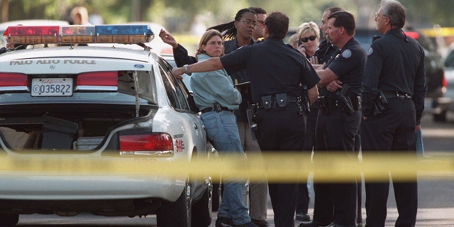Palo Alto Police Department officers conduct an impromptu conference at the scene on Ferne Avenue where three bodies were discovered in a home. Police would reveal little about the tragedy, but said they were looking into the possibility that it was a homicide-suicide. It was later revealed that Vladimir Pokhilko murdered his wife Yelena Fedotova and 12-year-old son Peter Pokhilko before taking his own life.