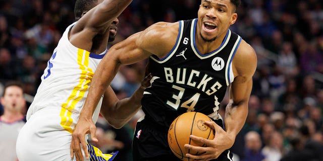 Milwaukee Bucks forward Giannis Antetokounmpo (34) drives for the basket around Golden State Warriors forward Draymond Green (23) during the third quarter at Fiserv Forum Dec 13, 2022, in Milwaukee.