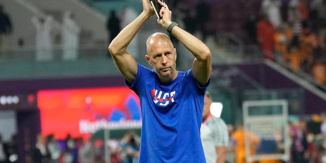 Head coach Gregg Berhalter of the United States salutes supporters at the end of the World Cup round of 16 soccer match between the Netherlands and the United States, at the Khalifa International Stadium in Doha, Qatar, Saturday, Dec. 3, 2022. 
