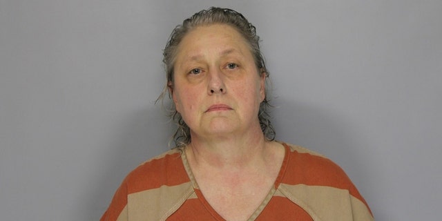 Fonda Spratt, 56, allegedly shot her neighbor twice over a complaint about barking dogs.