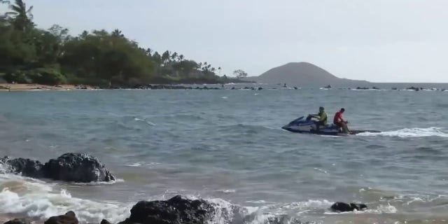 First responders search Thursday for a woman whose husband said she went missing while snorkeling after he saw a shark in Maui, Hawaii.