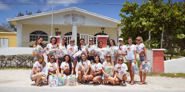 During this year’s calendar shoot, the models distributed coloring books, crayons, sunglasses and toiletries to children at Gateway Christian Academy in Bimini in the Bahamas.