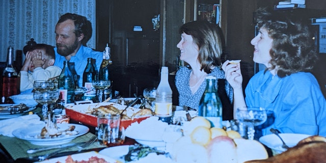Family dinner in the Pokhilko apartment in Russia with Vlaidmir Pokhilko, left, Peter Pokhilko, little boy, visitor Kathy Hunter, and Yelena Fedotova, front of right, circa 1991.