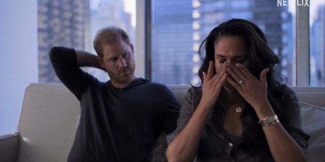 Meghan Markle is seen crying while sitting beside Prince Harry in a trailer for their Netflix docuseries "Harry &amp; Meghan."