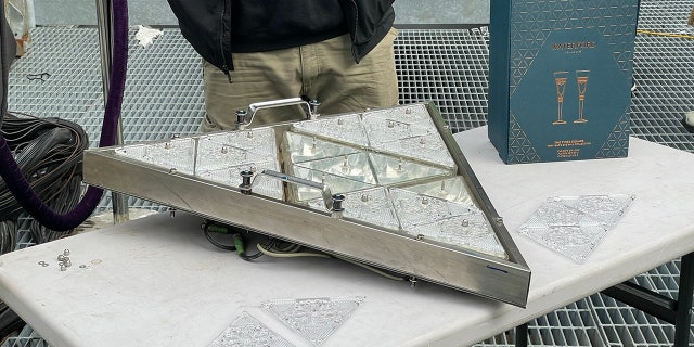 Waterford Crystal architects demonstrate how the triangular plates are set into place during the annual installation on Dec. 27, 2022.