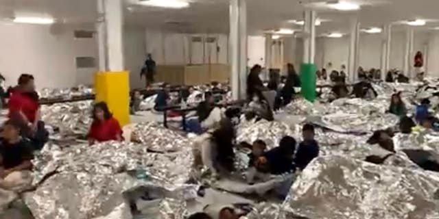 Migrants crammed into a processing facility. 
