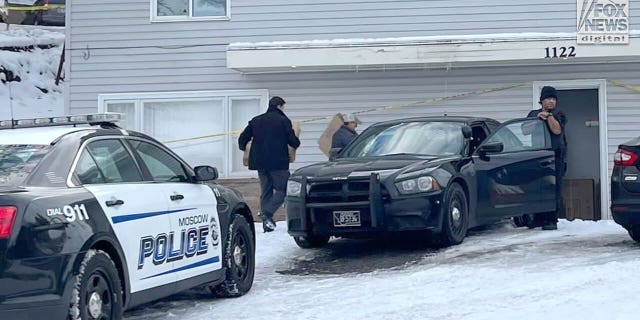 Police prepare to carry out victims' belongings from the house in Moscow, Idaho, on Dec. 7.