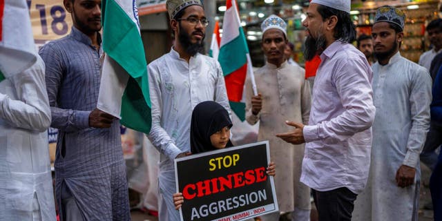 An Indian girl holds a placard during an anti-China protest in Mumbai, India on Tuesday, December 13, 2022.