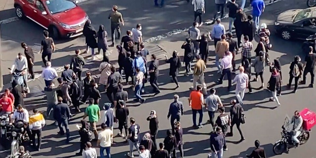 FILE: In this frame grab from a video, people are blocking an intersection during a protest to mark 40 days since the death in custody of 22-year-old Mahsa Amini, whose tragedy sparked Iran's biggest antigovernment movement in over a decade, in Tehran, Iran, Wednesday, Oct. 26, 2022.