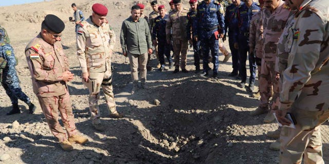 Iraqi Chief of General Staff Abdel Emir Yarallah, right, investigates the site where nine police officers died on Dec. 18 due to the bombing by Deash members in Southern Kirkuk, Iraq, on Dec. 19, 2022.