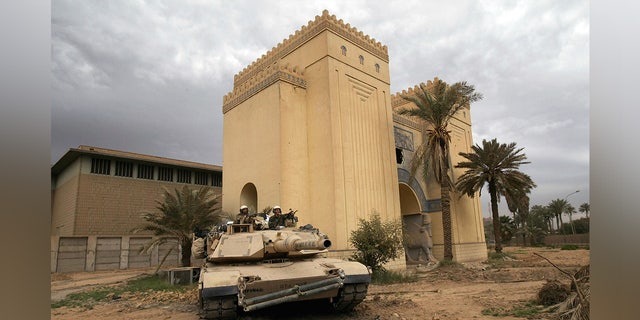 A U.S. tank takes up position outside the plundered Iraqi National Museum April 16, 2003 in Baghdad, Iraq. U.S. Defense Secretary Donald Rumsfeld rejected blame for soldiers who reportedly stood by as looting of priceless treasures from the museum occured, saying in a news conference that "it's difficult to stop." 
