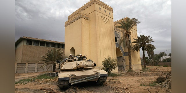 A U.S. tank takes up position outside the plundered Iraqi National Museum April 16, 2003 in Baghdad, Iraq. U.S. Defense Secretary Donald Rumsfeld rejected blame for soldiers who reportedly stood by as looting of priceless treasures from the museum occured, saying in a news conference that "it's difficult to stop."