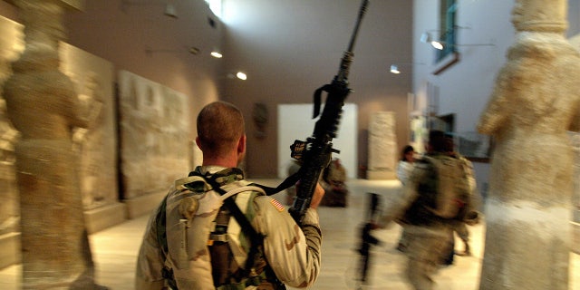 Two US soldiers from the 1st Division, 2nd Bridage, Texas, visit the Iraq Museum 10 September 2003 in Baghdad.