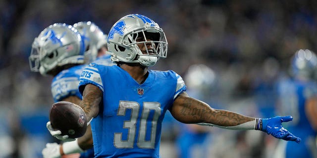 Detroit Lions running back Jamaal Williams looks toward fans after scoring a 1-yard touchdown during the first half of a game against the Jacksonville Jaguars Dec. 4, 2022, in Detroit.