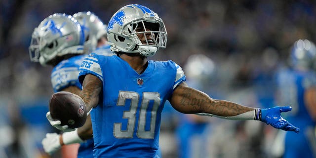 Detroit Lions running back Jamaal Williams looks up at the fans after scoring a 1-yard touchdown run during the first half of a game against the Jacksonville Jaguars on December 4, 2022 in Detroit.