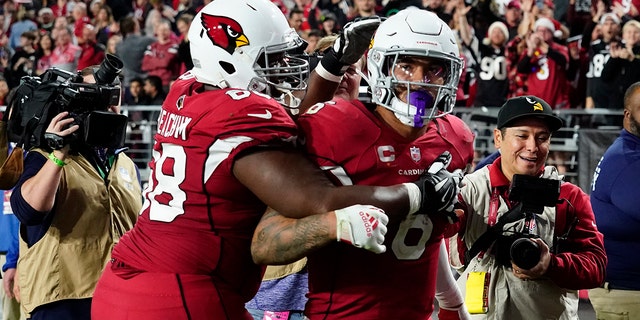 Arizona Cardinals running back James Conner (6) celebrates his touchdown with offensive tackle Kelvin Beachum against the Tampa Bay Buccaneers during the second half of an NFL football game, Sunday, Dec. 25, 2022, in Glendale, Ariz. 