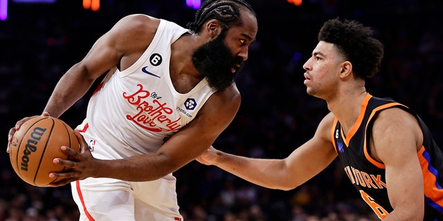 Philadelphia 76ers guard James Harden looks to drive past New York Knicks guard Quentin Grimes during the first half of an NBA basketball game, Sunday, Dec. 25, 2022, in New York.