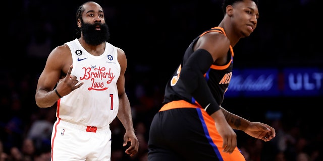 Philadelphia 76ers guard James Harden (1) reacts after making a three-point basket against New York Knicks guard RJ Barrett during the first half of an NBA basketball game, Sunday, Dec. 25, 2022, in New York.