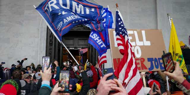 Protestors loyal to former-President Trump riot outside the Capitol in Washington, on Jan. 6, 2021. Suzanne Ianni, a former Natick official seen on video marching through the U.S. Capitol on Jan. 6, has been sentenced to 15 days in prison for her role in the protest.
