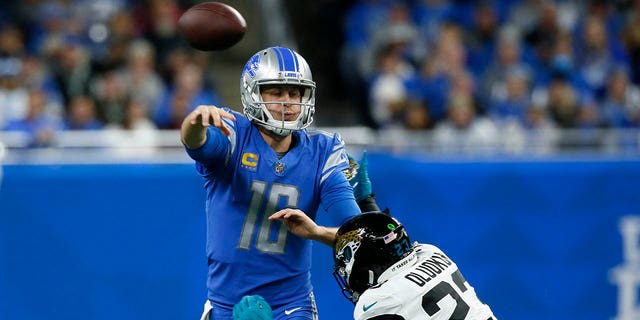 Detroit Lions quarterback Jared Goff (16) is pressured by Jacksonville Jaguars linebacker Foyesade Oluokun (23) during the first half of an NFL football game, Sunday, Dec. 4, 2022, in Detroit. 