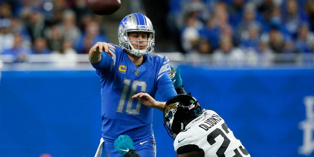 Detroit Lions quarterback Jared Goff (16) is pressured by Jacksonville Jaguars linebacker Foyesade Oluokun (23) during the first half of an NFL football game, Sunday, Dec. 4, 2022, in Detroit.