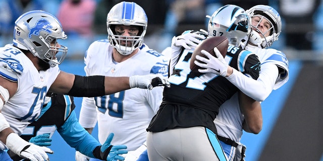 Yetur Gross-Matos #97 of the Carolina Panthers sacks Jared Goff #16 of the Detroit Lions during the fourth quarter of the game at Bank of America Stadium on December 24, 2022 in Charlotte, North Carolina.
