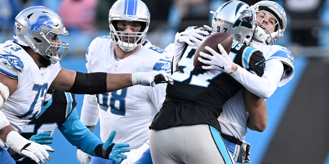 Yetur Gross-Matos #97 of the Carolina Panthers sacks Jared Goff #16 of the Detroit Lions during the fourth quarter of the game at Bank of America Stadium on December 24, 2022 in Charlotte, North Carolina.