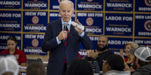 President Joe Biden speaks to volunteers at an International Brotherhood of Electrical Workers (IBEW) phone banking event on December 2nd, 2022 in Boston, Massachusetts for re-election campaign of Democratic Sen. Raphael Warnock of Georgia. (Photo by Nathan Posner/Anadolu Agency via Getty Images) 